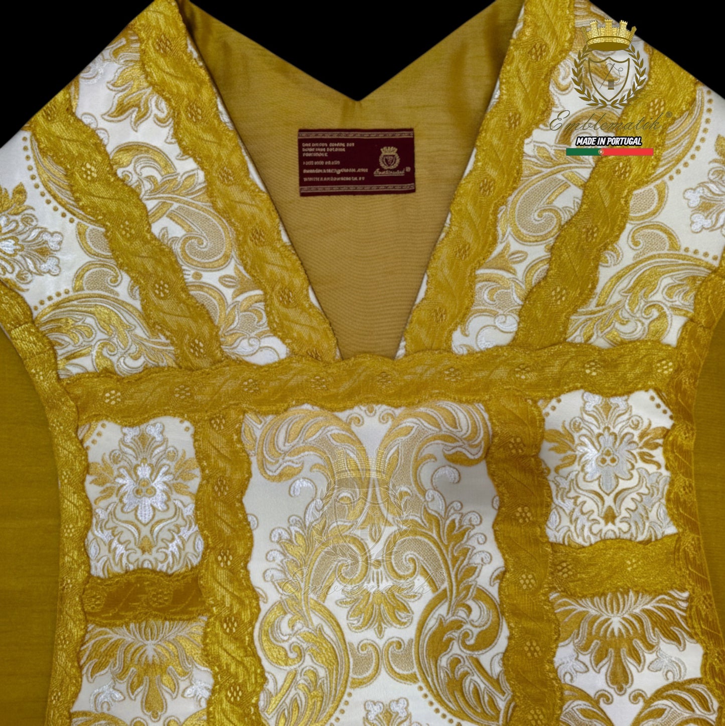 Emblematik by Pasamanerias y Bordados white floral low mass chasuble with gold trim and embroidery.