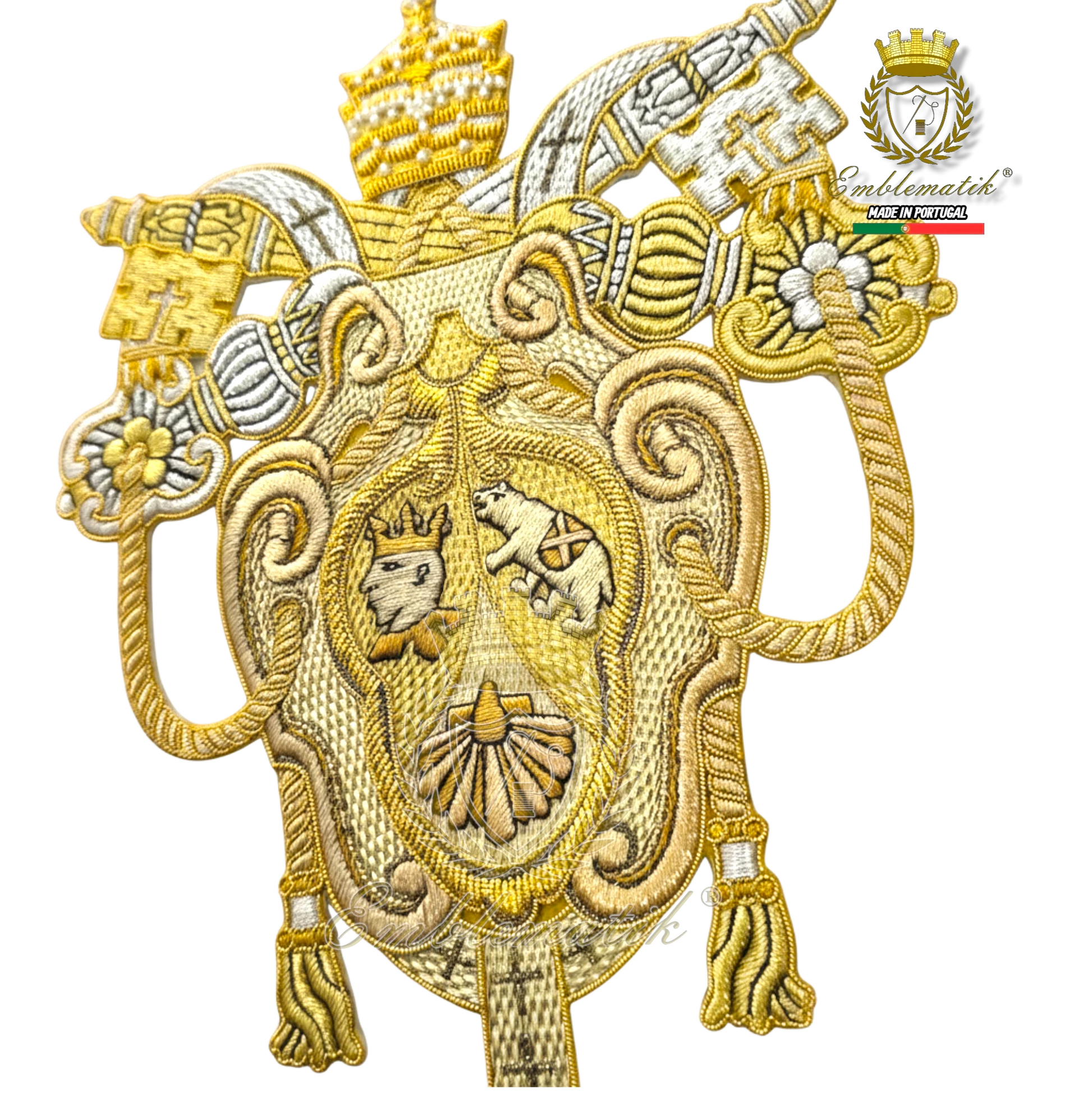 Emblematik by Pasamanerias y Bordados Papal Coat of Arms of Benedict XVI, gold and silver metallic thread embroidery, intricate detail.
