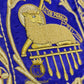 Emblematik by Pasamanerias y Bordados purple chasuble with gold metallic embroidery of Agnus Dei and cross.