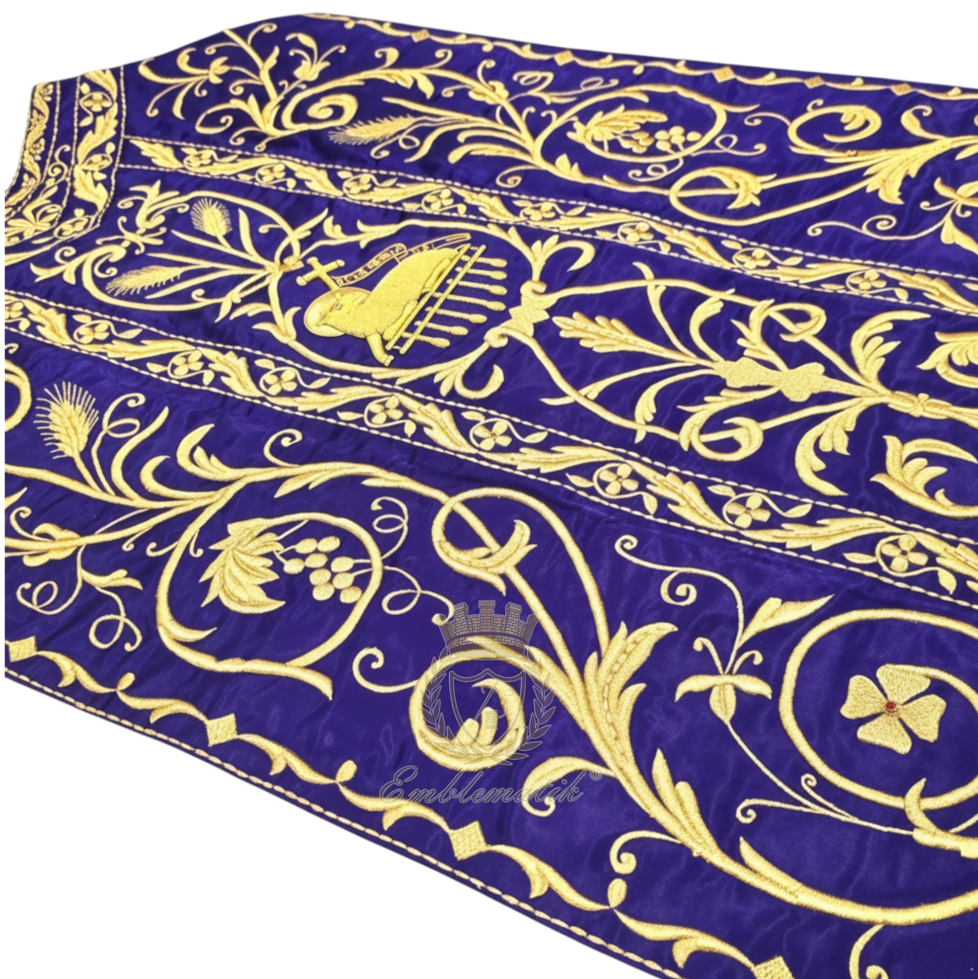 Emblematik by Pasamanerias y Bordados Roman Chasuble in purple with metallic gold embroidery of floral patterns and Agnus Dei.