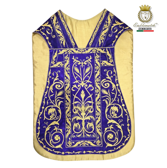 Emblematik by Pasamanerias y Bordados Roman Chasuble in purple with gold metallic embroidery of Agnus Dei and floral motifs.