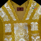 Emblematik by Pasamanerias y Bordados white floral low mass chasuble with gold trim and embroidery.