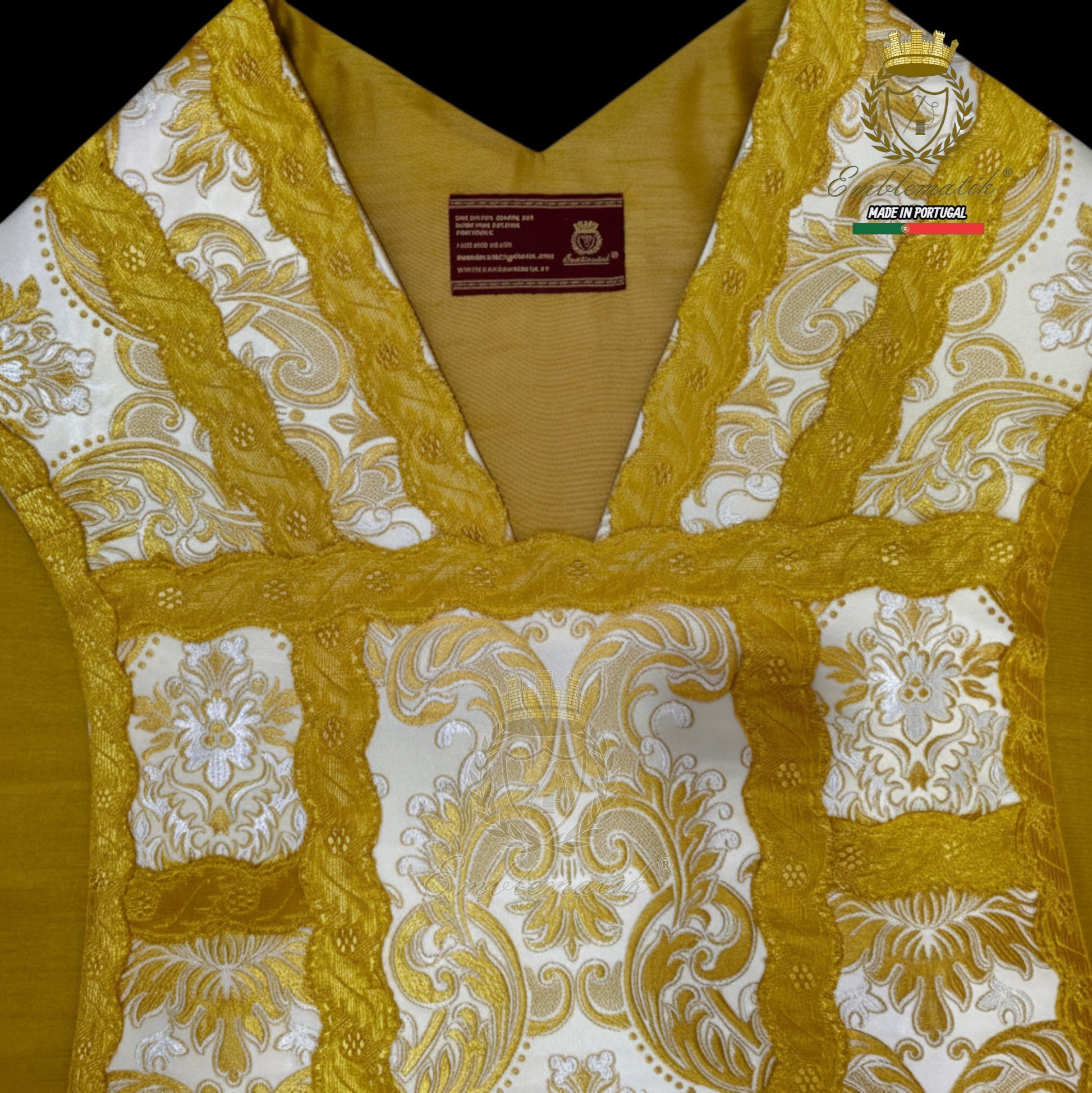 Emblematik by Pasamanerias y Bordados white floral low mass chasuble with gold trim and embroidery.